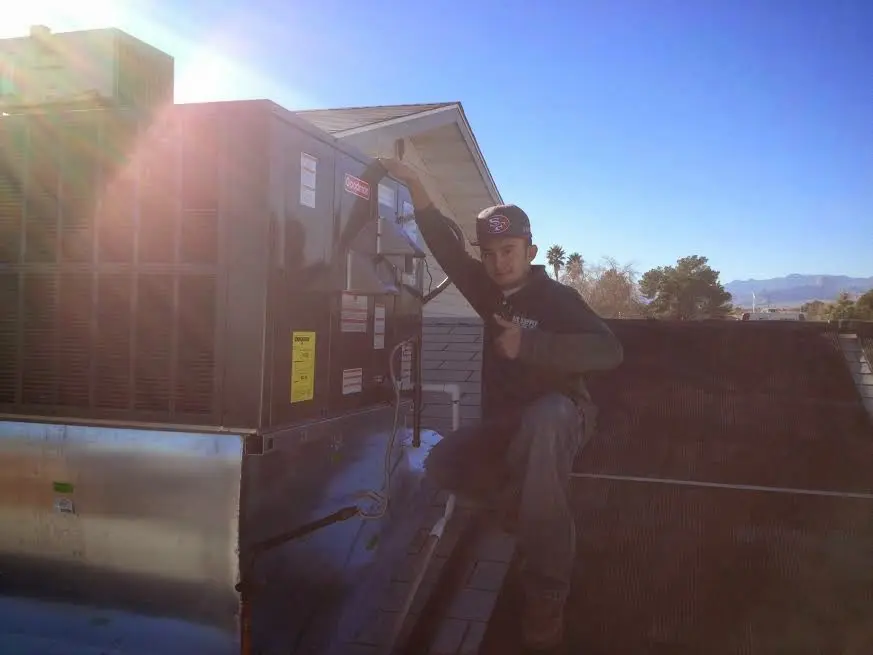 HVAC technician performing Air Duct Repair on a rooftop unit in Nashville